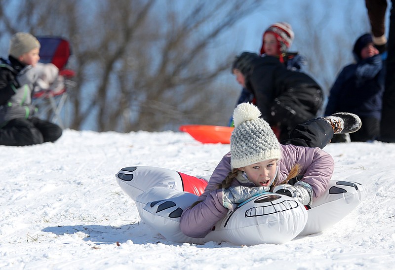 Monroe Bullington, 9, rides an inflatable Tuesday, February 16, 2021, down a hill at J.B. Hunt Park in Springdale. Temperatures dipped to 20 degrees below zero in some parts of the region over night Monday. Check out nwaonline.com/210217Daily/ and nwadg.com/photos for a photo gallery.
(NWA Democrat-Gazette/David Gottschalk)