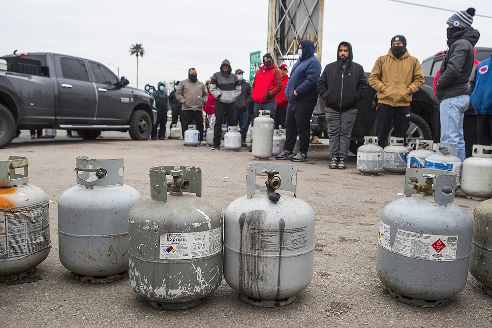 People line up to fill their empty propane tanks Tuesday, Feb. 16, 2021, in Houston. Temperatures stayed below freezing Tuesday, and many residents were without electricity. (Brett Coomer/Houston Chronicle via AP)