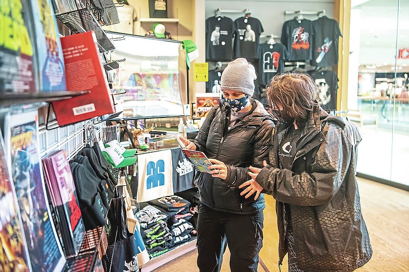 Iris Smith and Paxon Masters, 12, both of Sewickley, shop at the Living Dead Museum in the Monroeville Mall, Saturday, Feb. 6, 2021, in Monroeville, Pa.  The Living Dead Museum, an institution dedicated to honoring the seminal 1968 zombie film “Night of the Living Dead” and its auteur, George Romero, had been a fixture in downtown Evans City since 2013. (Alexandra Wimley /Pittsburgh Post-Gazette via AP)