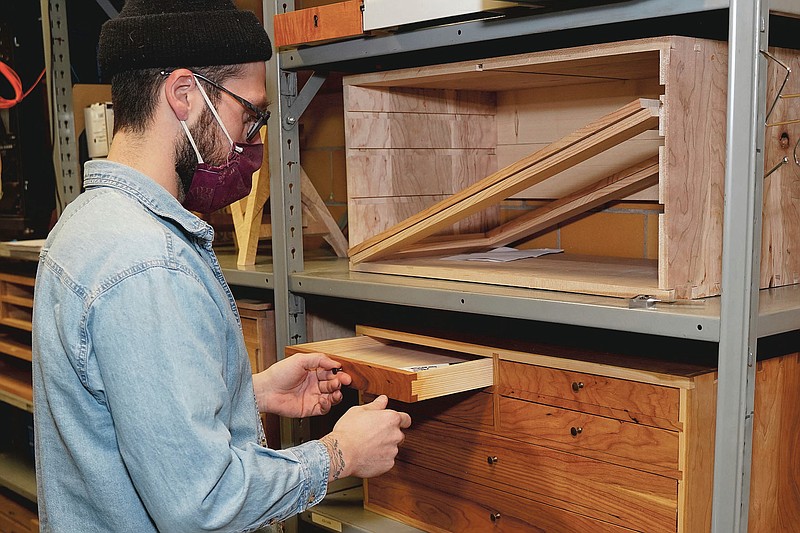 Zack Fealk, of Detroit, shows off a toolbox he made during the furniture making class at the Sam Beauford Woodworking Institute on Jan. 19, 2021, in Adrian, Mich. Students in the class make a variety of handcrafted wood projects. (Mike Dickie/The Daily Telegram via AP)