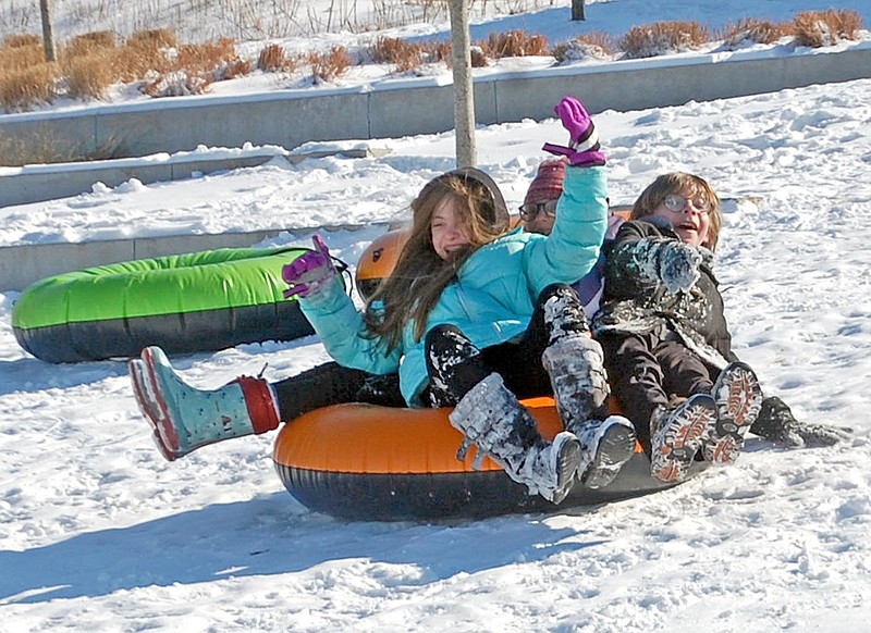 Janelle Jessen/Siloam Sunday
Children enjoy sledding in Memorial Park on Thursday. The hill was a popular place for sledding throughout the week.