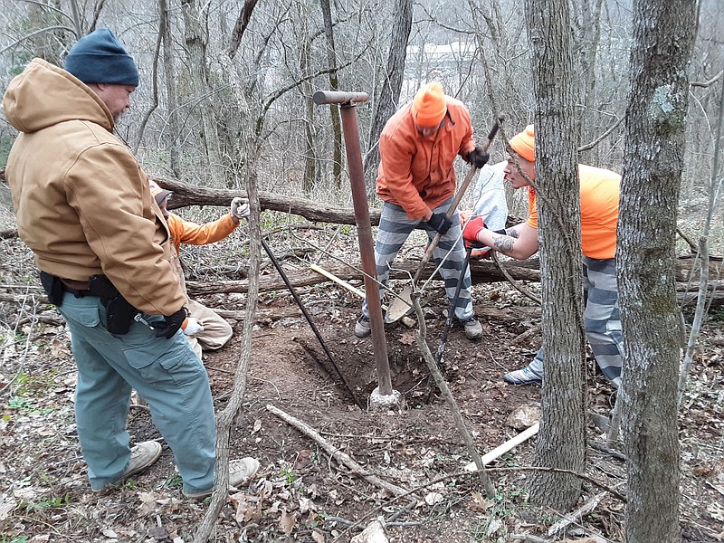 Photo courtesy Xyta Lucas
A Work Detail Team from the Benton County Jail unearths the first old clothesline pole from the former Robbins/Gore homestead last month.