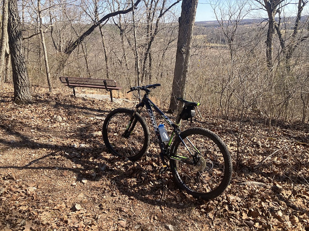 A bench helps trail trekkers enjoy a relaxing view of the War Eagle River valley. The view looks east to the site of the War Eagle Fair arts and crafts event.
(NWA Democrat-Gazette/Flip Putthoff)