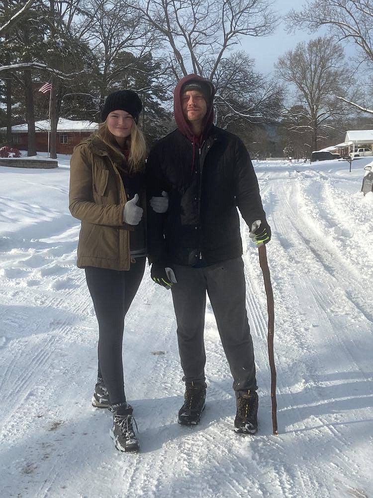 Rebecca Brenneman-Hull and Philip Hull, shown in the snow on Thursday, walked about 2 miles early Monday morning so Brenneman-Hull could reach her job as a labor and delivery nurse at CHI St. Vincent. - Submitted photo