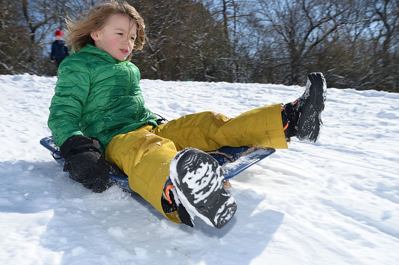 Murrell Craiglow, 7, of Fayetteville picks up speed Thursday as he heads downhill while sledding near North Street and College Avenue in Fayetteville. Go to nwaonline.com/210219Daily/ for today’s photo gallery.
(NWA Democrat-Gazette/Andy Shupe