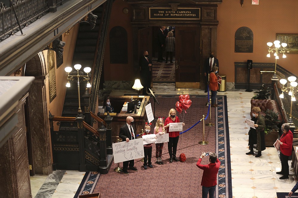 Supporters of a proposal that would ban almost all abortions in South Carolina gather outside the House chamber to thank lawmakers for passing the bill on Thursday, Feb. 18, 2021, in Columbia, S.C. The governor plans to sign the bill.
