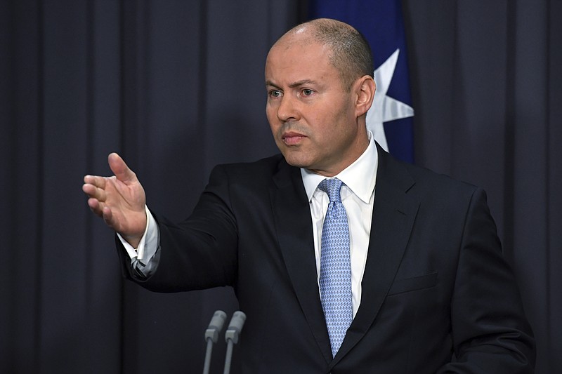 Australia's Treasurer Josh Frydenberg speaks at a press conference at Parliament House in Canberra, Thursday, Feb. 18, 2021. Frydenberg amended draft legislation after weekend talks with Facebook CEO Mark Zuckerberg and Sundar Pichai, chief executive of Alphabet Inc. and its subsidiary Google, to make it clear the platforms would not be charged per news snippet or link. (Mick Tsikas/AAP Image via AP)