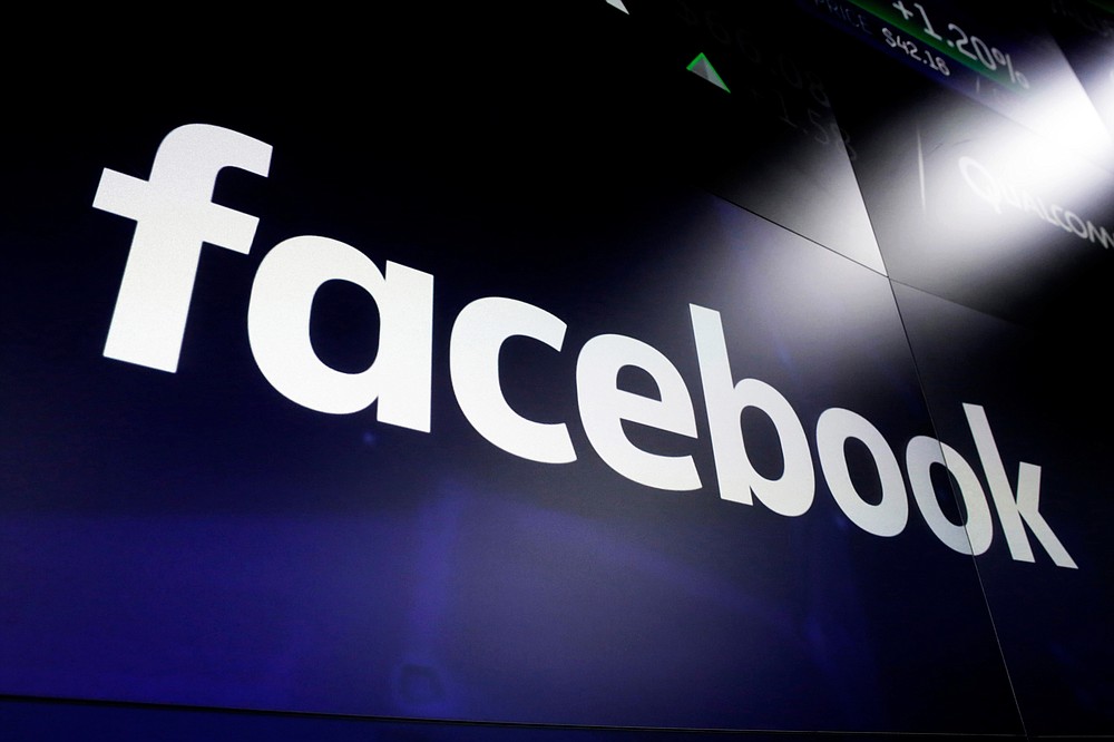 FILE - In this March 29, 2018, file photo, the Facebook logo on a screen at Nasdaq in Time Square, New York. Australia’s Parliament will debate making Google and Facebook pay for news after a Senate committee on Friday, Feb. 12, 2021 recommended no changes to the world-first draft laws. (AP Photo/Richard Drew, File)