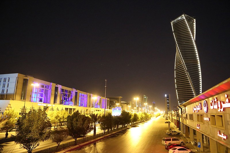 Light illuminate the Al Majdoul skyscraper and a city road at night in Riyadh, Saudi Arabia, on Tuesday, July 28, 2020. Saudi Arabia suffered a simultaneous decline in oil and non-oil revenue as the global pandemic combined with lower energy prices to jolt the kingdom's public finances. MUST CREDIT: Bloomberg photo by Maya Anwar