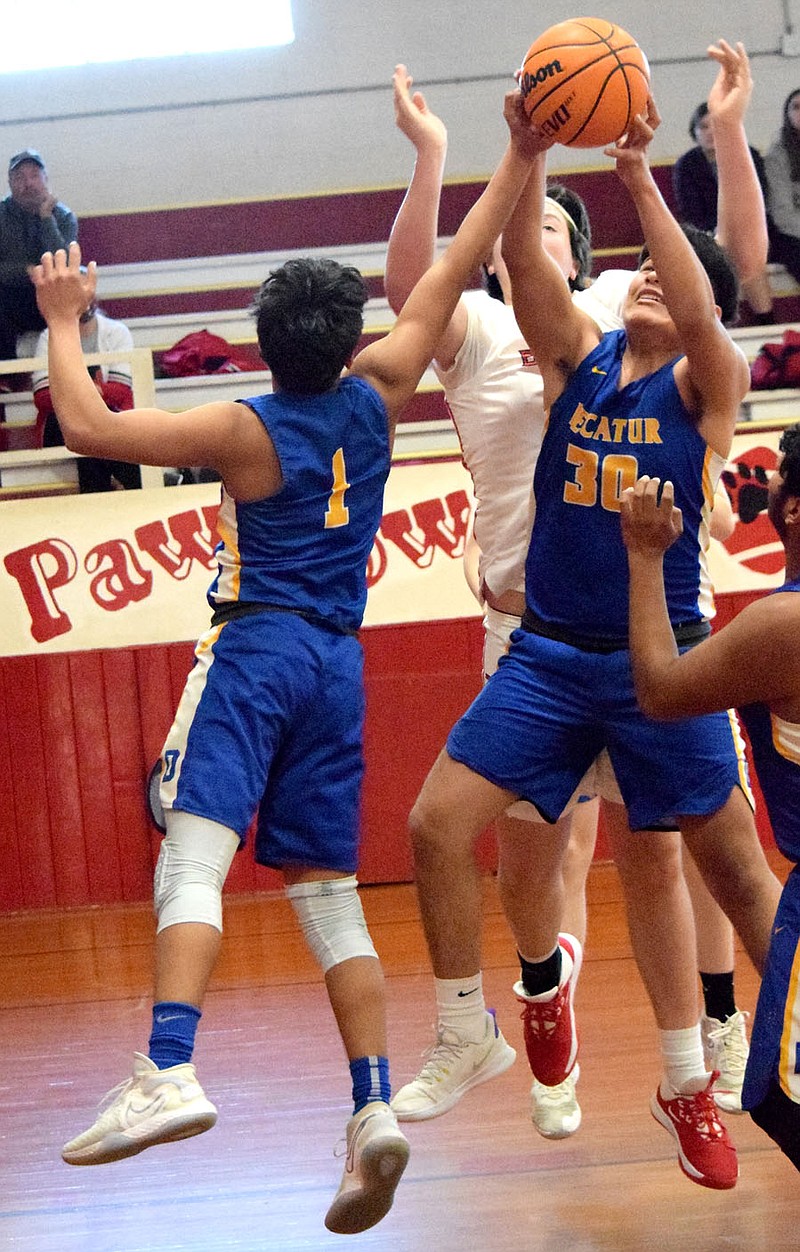 Westside Eagle Observer/MIKE ECKELS
Bulldog Enrique Rubi (1) tries to push a rebound ball further into the hands of team mate Edgar Herrera (30) during the third quarter of Friday afternoon's Flippin-Decatur district contest at the middle school gym in Flippin. Rubi's help allowed Herrera to get a better grip on the ball which in turn earn a field goal for Decatur. story.lead_photo.caption