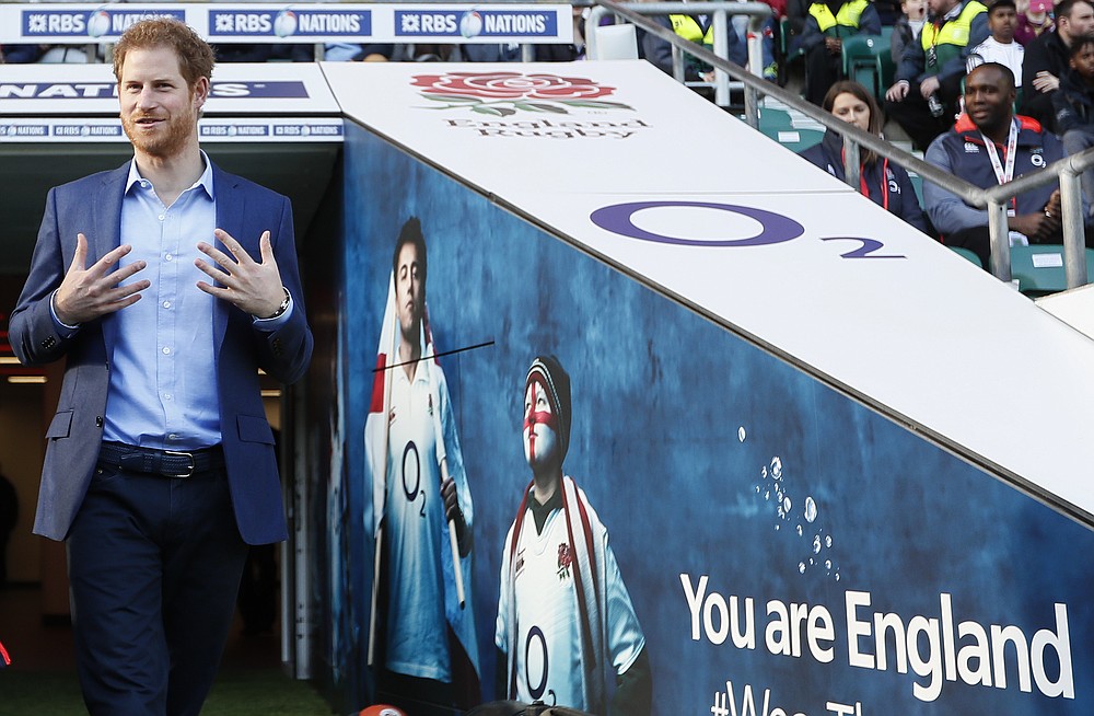 FILE - In this Feb. 17, 2017 file photo Britain's Prince Harry walks from the tunnel during a visit to an England Rugby Squad training session at Twickenham Stadium in London. Harry and Meghan stepped away from full-time royal life in early 2020, and Buckingham Palace on Friday Feb. 19, 2021, confirmed the couple will not be returning to royal duties, and Harry will give up his honorary military titles. (AP Photo/Kirsty Wigglesworth, pool, File)