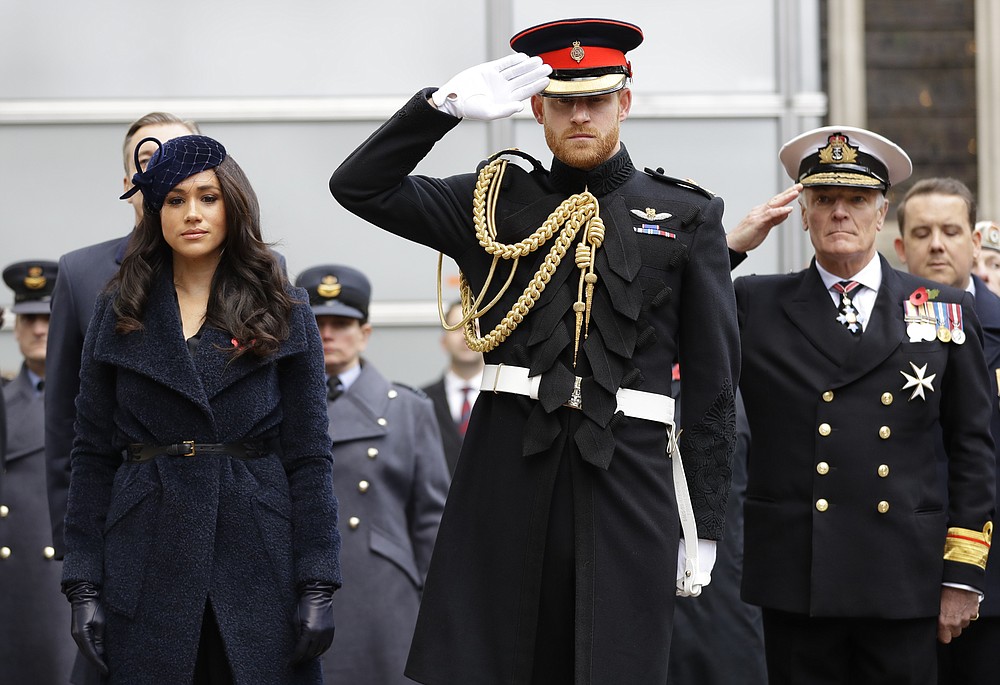 FILE - In this Nov. 7, 2019 file photo Britain's Prince Harry and Meghan, the Duchess of Sussex attend the 91st Field of Remembrance at Westminster Abbey in London. Harry and Meghan stepped away from full-time royal life in early 2020, and Buckingham Palace on Friday Feb. 19, 2021, confirmed the couple will not be returning to royal duties, and Harry will give up his honorary military titles. (AP Photo/Kirsty Wigglesworth, pool)