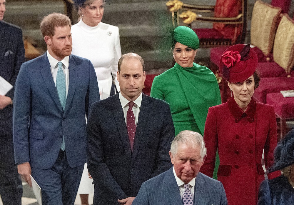 FILE - In this file photo dated Monday March 9, 2020, from back, Britain's Prince Harry and Meghan Duchess of Sussex, Prince William and Kate, Duchess of Cambridge, with Prince Charles, front, as the family members leave the annual Commonwealth Service at Westminster Abbey in London. Harry and Meghan stepped away from full-time royal life early 2020, and Buckingham Palace on Friday Feb. 19, 2021, confirmed the couple will not be returning to royal duties, and Harry will give up his honorary military titles.(Phil Harris / Pool FILE via AP)