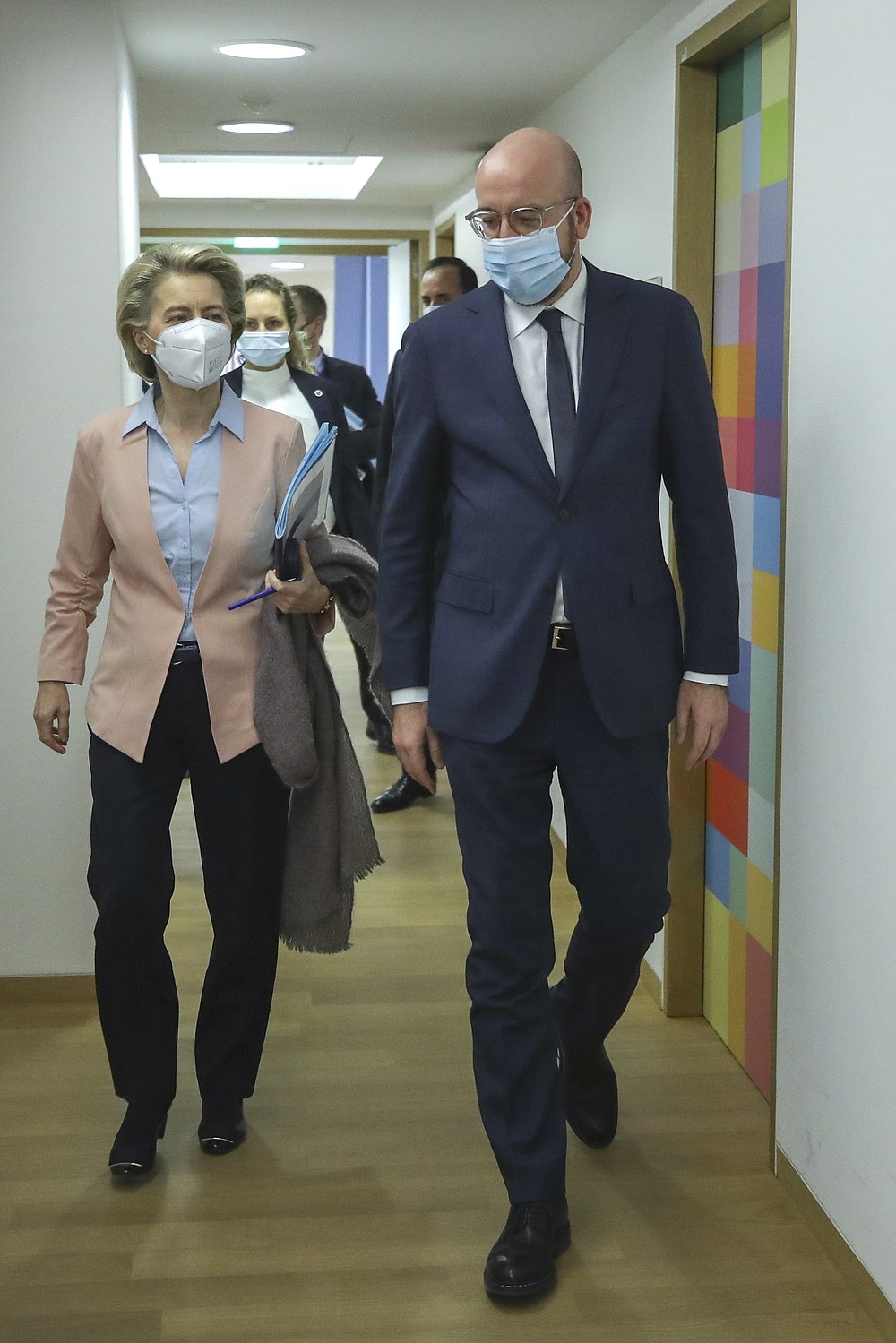 European Commission President Ursula von der Leyen, left, and European Council President Charles Michel arrive as they prepare to take part in an online meeting of G7 leaders at the European Council building in Brussels, Friday, Feb. 19, 2021. (Olivier Hoslet, Pool via AP)