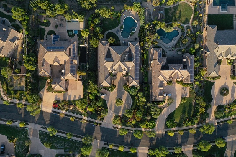 Single-family homes with rooftop solar panels and backyard pools are seen in this aerial photograph taken over a Lennar Corp. development in San Diego on Sept. 1, 2020. MUST CREDIT: Bloomberg photo by Bing Guan.