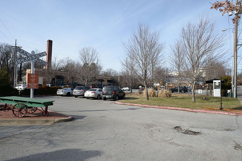 Cars are parked Jan. 21, 2020, in a parking lot on West Avenue in Fayetteville. The City Council held on a decision Thursday over a contract pertaining to the location of a planned parking deck associated with the cultural arts corridor downtown.
(File photo/NWA Democrat-Gazette/Andy Shupe)