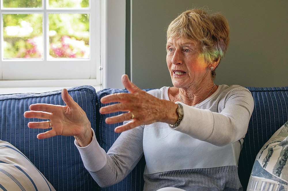 Prue Taylor gestures as she recalls events of 10 years ago when she lost her husband in Brian in an earthquake when he was crushed in the CTV building collapse in Christchurch, New Zealand, Wednesday, Feb. 10, 2021. One woman has used her anger to ensure buildings are safer. Others have found peace after heartbreaking losses. Ten years after the earthquake in Christchurch killed 185 people and devastated the city, some of those profoundly affected are sharing their journeys. (AP Photo/Peter Meecham)