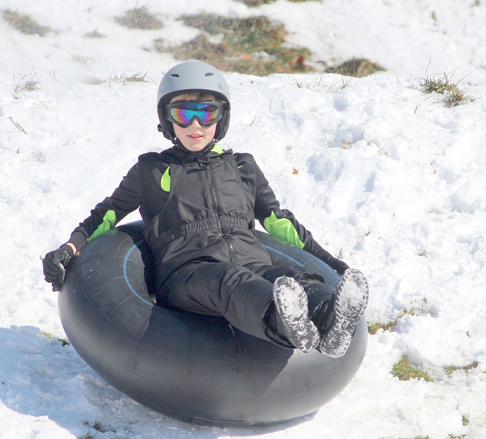 Keith Bryant/The Weekly Vista
Cade Phillips, 12, tubes down the Lake Ann dam last Friday morning.