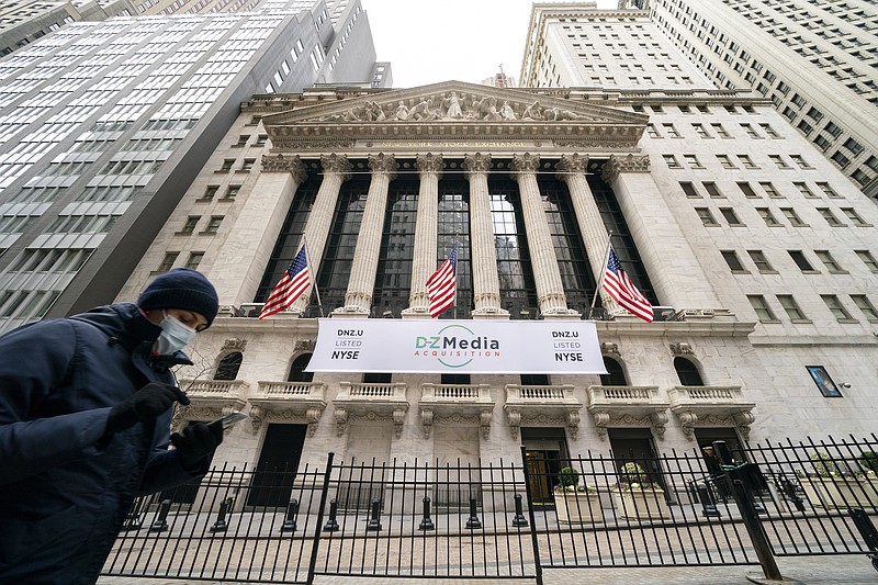 FILE - Pedestrians pass the New York Stock Exchange, Wednesday, Jan. 27, 2021, in New York.  Stocks are opening higher on Wall Street following three straight days of losses. The S&P 500 rose 0.2% in the first few minutes of trading Friday, Feb. 19.   (AP Photo/John Minchillo, File)