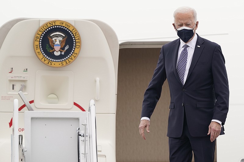 President Joe Biden stands at the top of the steps of Air Force One at Andrews Air Force Base, Md., Friday, Feb. 19, 2021. Biden is heading to Michigan to visit a Pfizer vaccine manufacturing plant near Kalamazoo. (AP Photo/Susan Walsh)