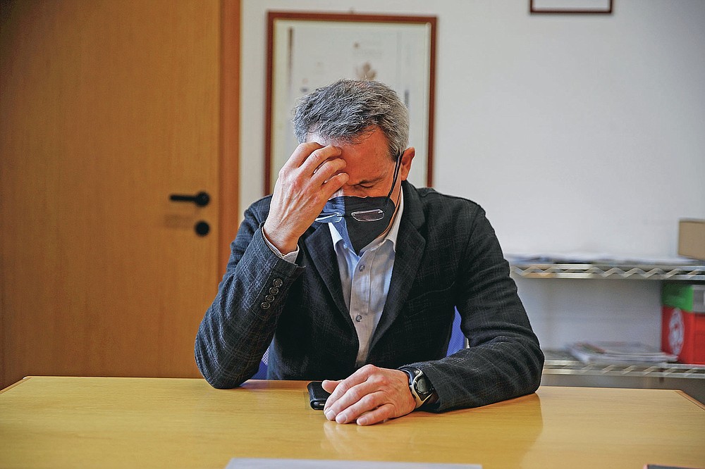 Vo' Euganeo mayor Giuliano Martini is interviewed by the Associated Press at the town hall, in Vo Euganeo, northern Italy, Wednesday, Feb. 10, 2021. Shockwaves ran through the wine-making village of Vo, west of Venice, as word spread last Feb. 21 that a retired roofer had died of the new coronavirus becoming the first known COVID-19 victim in the West. (AP Photo/Luca Bruno)