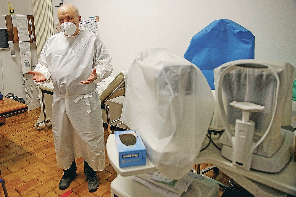 Doctor Luca Rossetto speaks during an interview with the Associated Press at his medical office, in Vo Euganeo, northern Italy, Wednesday, Feb. 10, 2021. Shockwaves ran through the wine-making village of Vo, west of Venice, as word spread last Feb. 21 that a retired roofer had died of the new coronavirus becoming the first known COVID-19 victim in the West. (AP Photo/Luca Bruno)