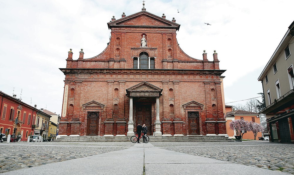 FILE - In this file photo taken on Thursday, March 12, 2020, a view of the almost empty main square in Codogno, Italy. Italy delivered the first shocking confirmation of locally transmitted coronavirus infections outside of Asia a year ago Sunday, with back-to-back revelations of cases more than 150 kilometers (nearly 100 miles) apart in the country's north. First, a 38-year-old man in Codogno, an industrial town in the Lombardy region, tested positive for COVID-19, sending panicked residents to pick up their children from school, stock up on provisions at grocery stores and search in vain for surgical masks at pharmacies. (AP Photo/Antonio Calanni, File)