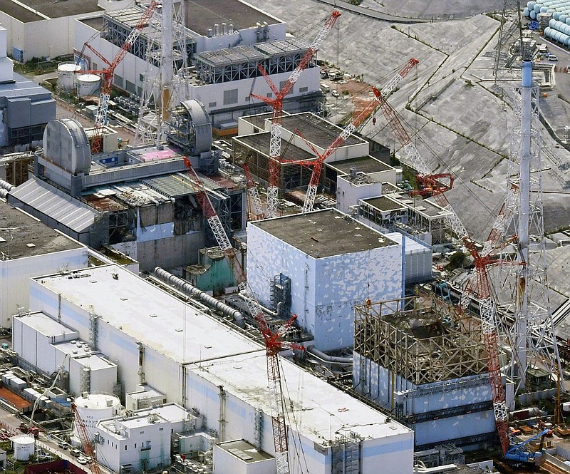 FILE - This Sept. 4, 2017, aerial file photo shows Fukushima Dai-ichi nuclear power plant's reactors, from bottom at right, Unit 1, Unit 2 and Unit 3, in Okuma, Fukushima prefecture, northeastern Japan. The utility operating a wrecked Fukushima nuclear plant said Friday, Feb. 19, 2021, it has detected cooling water levels at two of its three melted reactors have fallen over the past few days apparently due to additional damage done to its reactors from a powerful earthquake that shook the area last weekend.(Daisuke Suzuki/Kyodo News via AP, File)