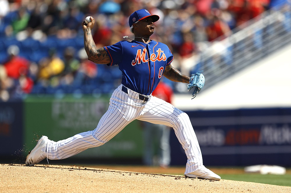 FILE - In this March 4, 2020 file photo, New York Mets pitcher Marcus Stroman throws a pitch to the St. Louis Cardinals during the first inning of a spring training baseball game in Port St. Lucie, Fla. Stroman, David Price, Buster Posey, and more than a dozen other players who opted out of the pandemic-shortened 2020 season get back to work this week. They not only will have to deal with rust but the demands of MLB’s coronavirus safety protocols. (AP Photo/Julio Cortez, File)