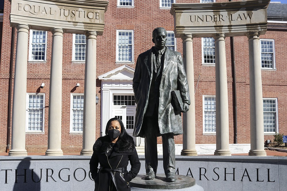 Maryland Del. Vanessa Atterbeary, a Democrat who chaired a panel of lawmakers that studied police reform initiatives last year that are now part of legislation before Maryland lawmakers, stands by a statue of former Supreme Court Justice Thurgood Marshall on Thursday, Feb. 4, 2021 in Annapolis, Md. (AP Photo/Brian Witte)