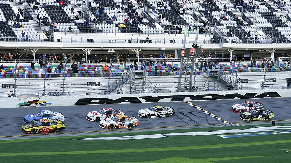 Brett Moffitt (02) and Austin Cindric (22) lead the field to start the NASCAR Xfinity Series road course auto race at Daytona International Speedway, Saturday, Feb. 20, 2021, in Daytona Beach, Fla. (AP Photo/John Raoux)