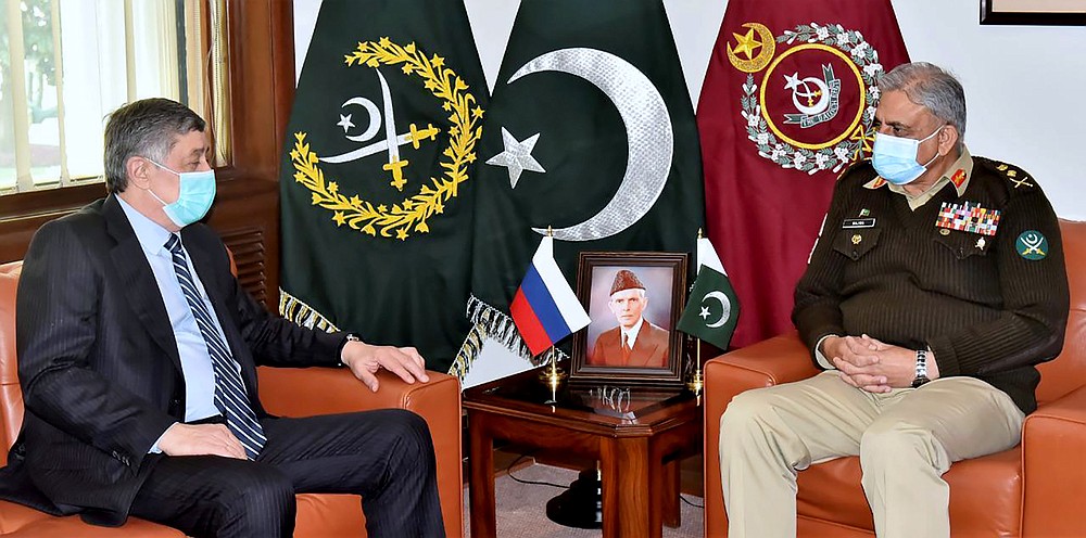 In this photo released by Inter Services Public Relations, Zamir Kabulov, left, Russia's President Vladimir Putin's special envoy on Afghanistan meets with Pakistan's Army Chief General Qamar Javed Bajwa, I Rawalpindi, Pakistan, Friday, Feb. 19, 2021. Kabulov was in Pakistan, a key regional player in efforts to find a peaceful end to Afghanistan's protracted war. During his unannounced visit , Kabulov met Pakistan's powerful army chief as well as the foreign minister. Few details came out of the meeting except that Afghanistan and getting to a peace deal dominated talks. Last month a delegation of the Taliban was in Moscow. (Inter Services Public Relations via AP)