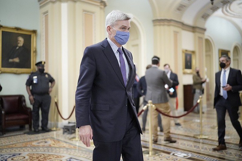 Sen. Bill Cassidy, R-La., walks in the Capitol as the Senate proceeds in a rare weekend session for final arguments in the second impeachment trial of former President Donald Trump, at the Capitol in Washington, Saturday, Feb. 13, 2021. (AP Photo/J. Scott Applewhite)