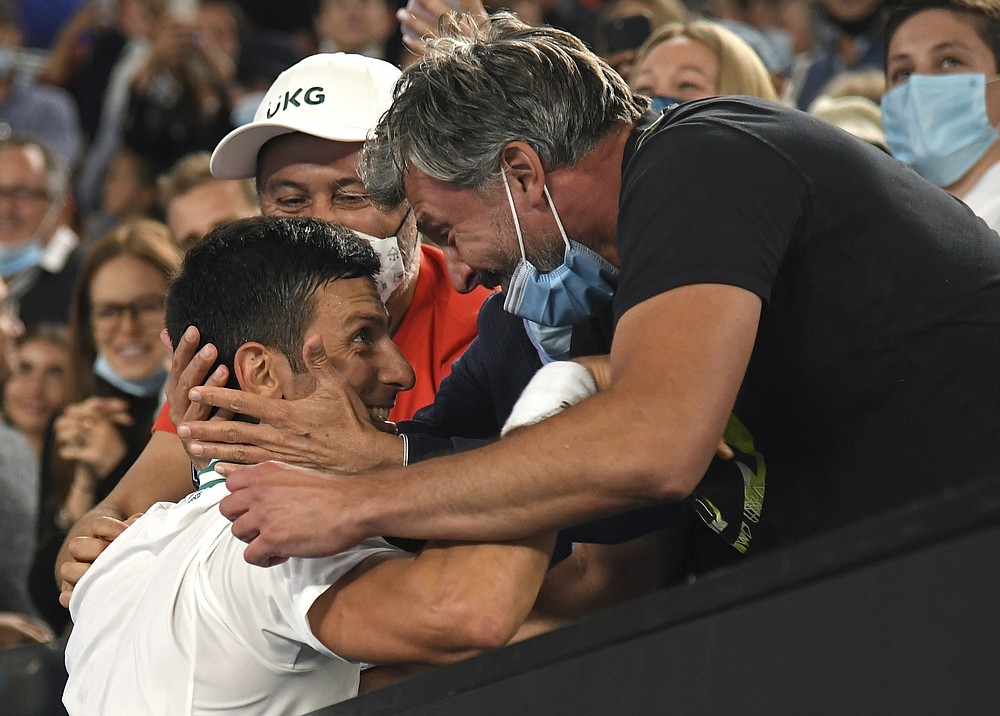 Serbia's Novak Djokovic celebrates with Goran Ivanisevic, right, and his support team after defeating Russia's Daniil Medvedev in the men's singles final at the Australian Open tennis championship in Melbourne, Australia, Sunday, Feb. 21, 2021.(AP Photo/Andy Brownbill)