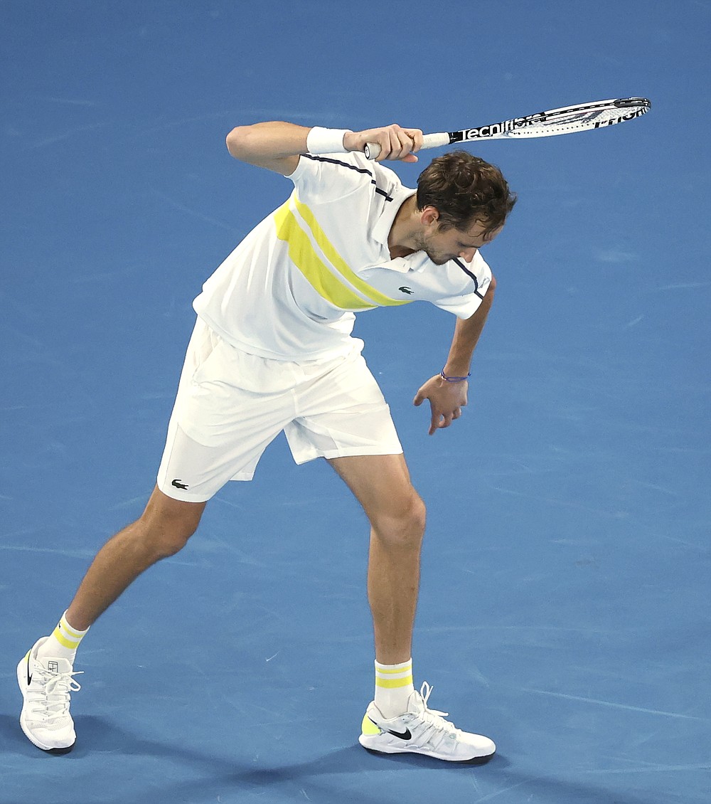 Russia's Daniil Medvedev raises his racket as if to smash it on the court while playing Serbia's Novak Djokovic during the men's singles final at the Australian Open tennis championship in Melbourne, Australia, Sunday, Feb. 21, 2021. (AP Photo/Hamish Blair)