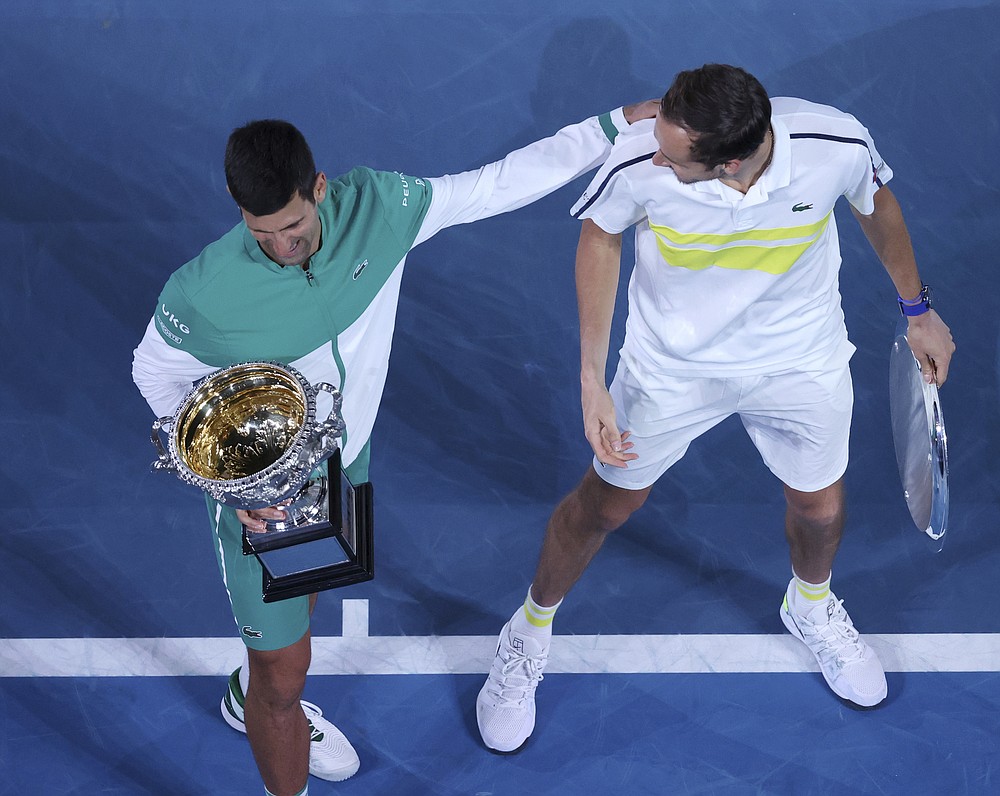 Serbia's Novak Djokovic, left, and Russia's Daniil Medvedev talk after receiving their trophies after Djokovic won the men's singles final at the Australian Open tennis championship in Melbourne, Australia, Sunday, Feb. 21, 2021. (AP Photo/Hamish Blair)
