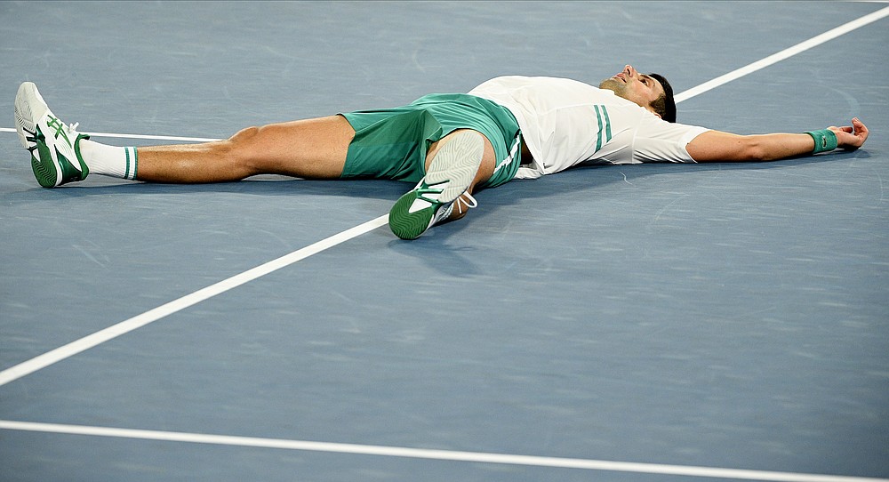 Serbia's Novak Djokovic celebrates after defeating Russia's Daniil Medvedev in the men's singles final at the Australian Open tennis championship in Melbourne, Australia, Sunday, Feb. 21, 2021.(AP Photo/Andy Brownbill)