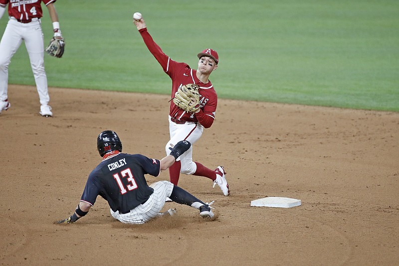 Arkansas second baseman Robert Moore (1) steps on the bag before throwing to first base to complete a double play during Saturday's game against Texas Tech during the 2021 State Farm College Baseball Showdown at Globe Life Field in Arlington, Texas. - Photo by James D. Smith, Special to the Democrat-Gazette