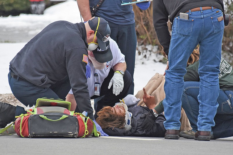Emergency responders prepare a pedestrian to be loaded into an ambulance Sunday after he was struck by a car on the 4600 block of Asher Avenue in Little Rock.
(Arkansas Democrat-Gazette/Staci Vandagriff)
