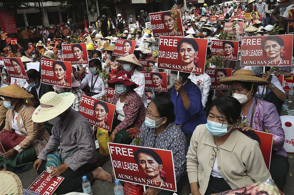 Protesters hold images of ousted leader Aung San Suu Kyi during an anti-coup protest in Mandalay, Myanmar, Sunday, Feb. 21, 2021. Police in Myanmar shot dead a few anti-coup protesters and injured several others on Saturday, as security forces increased pressure on popular revolt against the military takeover. (AP Photo)