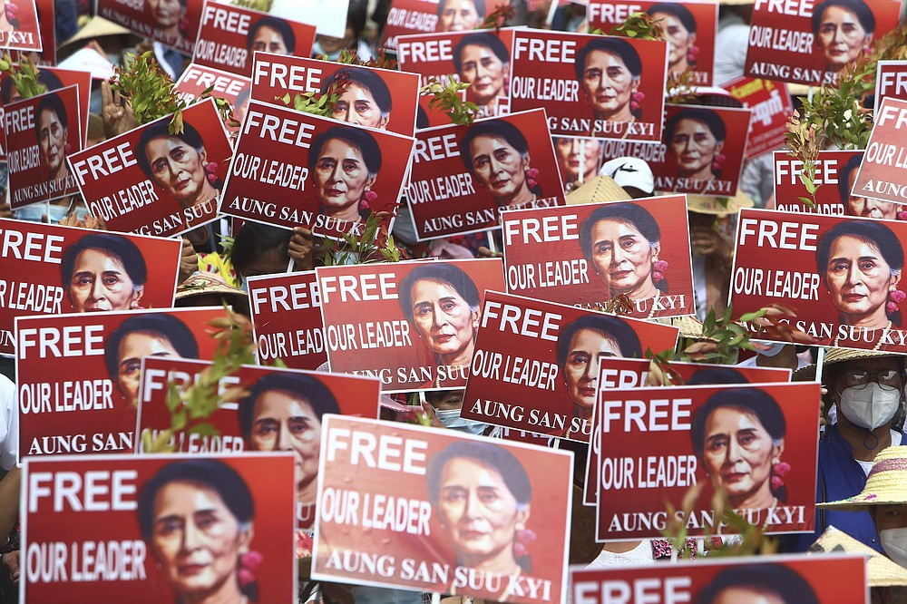 Protesters hold up placard with images of ousted leader Aung San Suu Kyi during an anti-coup protest in Mandalay, Myanmar, Sunday, Feb. 21, 2021. Police in Myanmar shot dead a few anti-coup protesters and injured several others on Saturday, as security forces increased pressure on popular revolt against the military takeover. (AP Photo)
