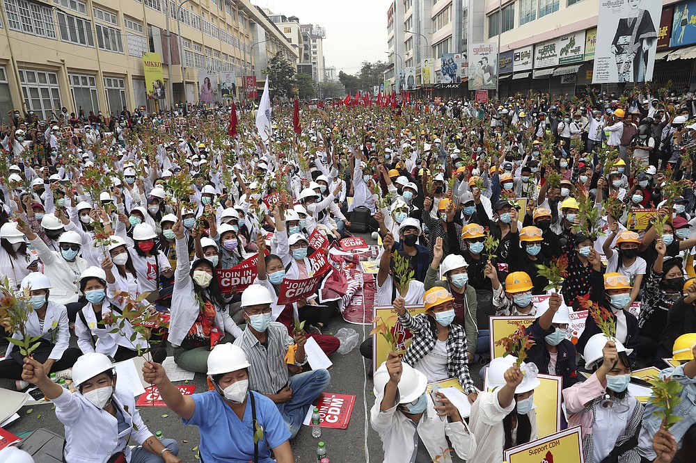 Students from the University of Medicine protest demonstrating by holding the brunches of Eugenia which is in the belief that the uprising is going to have succeeded, during an anti-coup protest in Mandalay, Myanmar, Sunday, Feb. 21, 2021. Police in Myanmar shot dead a few anti-coup protesters and injured several others on Saturday, as security forces increased pressure on popular revolt against the military takeover. (AP Photo)