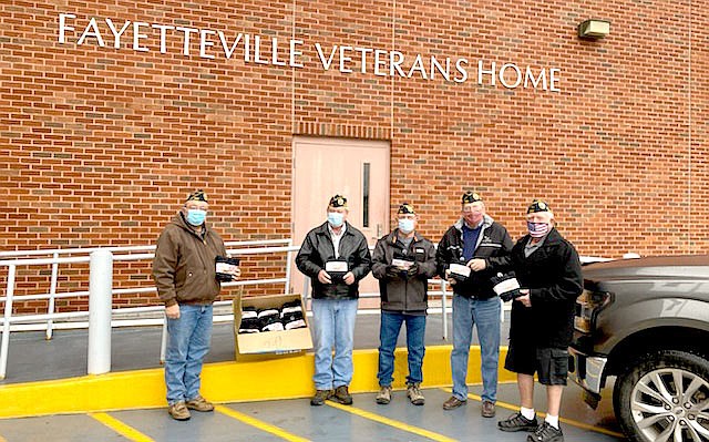 Photo Submitted On Feb. 8, Disabled American Veterans (DAV) members Mike Carnahan (left), Frank Lee, Dan Dover, Art Lawless and Ron Evans delivered socks to the residents at the Fayetteville Veterans Home. Shoe Sensation, in coordination with the DAV held it's annual Socks for Troops campaign in December and the store collected 518 pairs of socks for the veterans. "We just asked every single customer and people were wanting to donate," said Shoe Sensation Manager Stephanie Evans-Rutherford. "I don’t know what it was this year but everybody said yes." The socks were supposed to be delivered in January, but Evans-Rutherford's father, Ron Evans, had a total knee replacement so they put it off a month so he could recover.