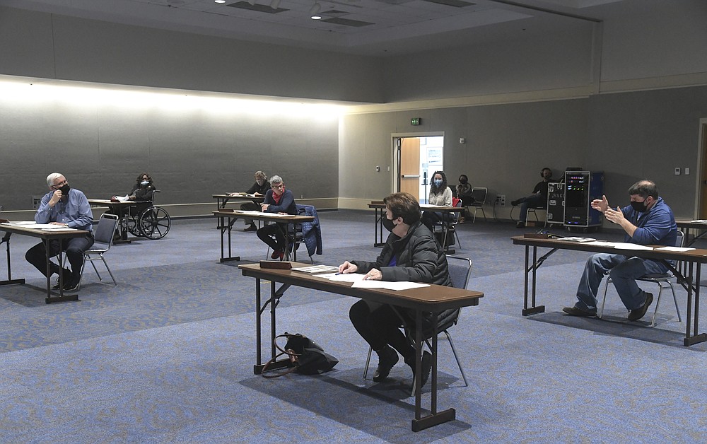 Commissioner Chris Dunkel, right, speaks to Visit Hot Springs CEO Steve Arrison, left, during Monday’s meeting of the Hot Springs Advertising and Promotion Commission at the Hot Springs Convention Center. - Photo by Grace Brown of The Sentinel-Record