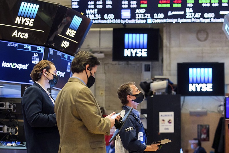 In this photo provided by the New York Stock Exchange, traders work on the floor, Monday Feb. 22, 2021. Investors remain focused on the future of global economies badly hit by COVID-19 and the potential for more stimulus to fix them.  (Courtney Crow/New York Stock Exchange via AP)
