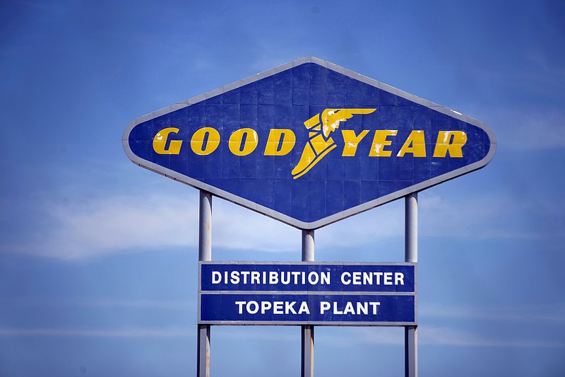 FILE - In this Aug. 20, 2020 file photo, signage for the Goodyear Distribution Center stands in Topeka, Kan. Goodyear Tire and Rubber Co. is acquiring Cooper tires in a deal valued at $2.5 billion that will combine the two century-old Ohio companies.  (Evert Nelson/The Topeka Capital-Journal via AP, File)