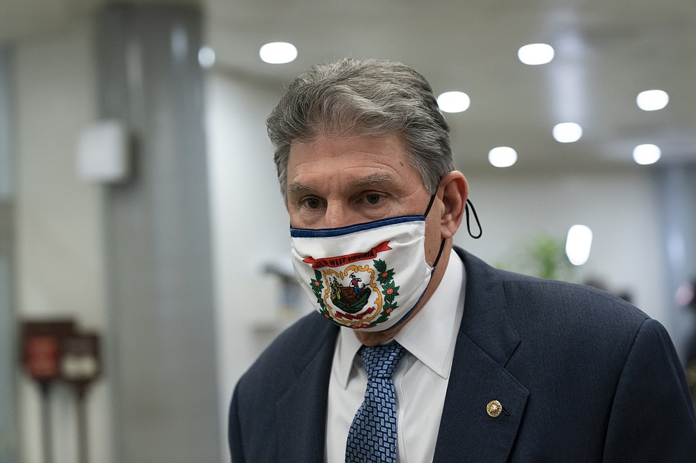 FILE - In this Feb. 13, 2021, file photo Sen. Joe Manchin, D-W.Va., departs on Capitol Hill in Washington. (AP Photo/Alex Brandon, File)