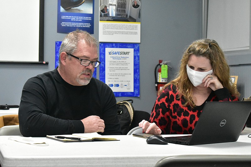 Mike Beatty, Liberty Utilities vice president for water and gas, and utility spokesperson Kelli Price speak during a teleconference from the Liberty office in Pine Bluff on Monday. (Pine Bluff Commercial/I.C. Murrell)