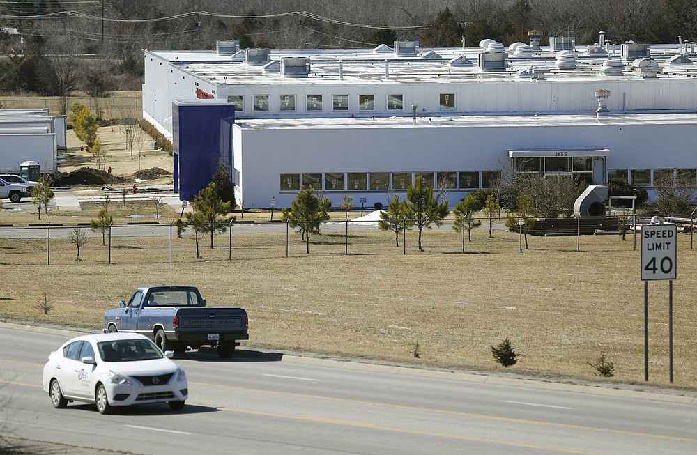 Traffic passes by the former Standard Register Co. building Monday, February 22, 2021, located at 3655 S. School Ave. in Fayetteville. Plans are in the works to turn the building into a 99,000-square-foot warehouse with a nearly 40,000-square-foot office and showroom. Check out nwaonline.com/210223Daily/ and nwadg.com/photos for a photo gallery.
(NWA Democrat-Gazette/David Gottschalk)