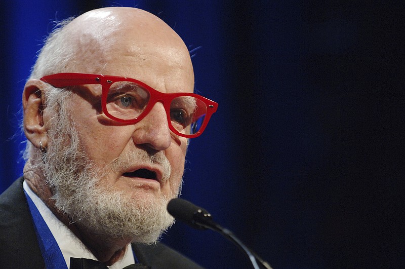 FILE - Author Lawrence Ferlinghetti recites a poem after he was awarded the Literarian Award for Outstanding Service to the American Literary Community at the National Book Awards in New York, on Nov. 16, 2005. Ferlinghetti, a poet, publisher and bookseller has died in San Francisco at age 101. His son says Ferlinghetti died at home on Monday, Feb. 22, 2021. Ferlinghetti helped launch and perpetuate the Beat movement. He was known for his City Lights bookstore in San Francisco, an essential meeting place for the Beats and other bohemians in the 1950s and beyond. (AP Photo/Henny Ray Abrams, File)